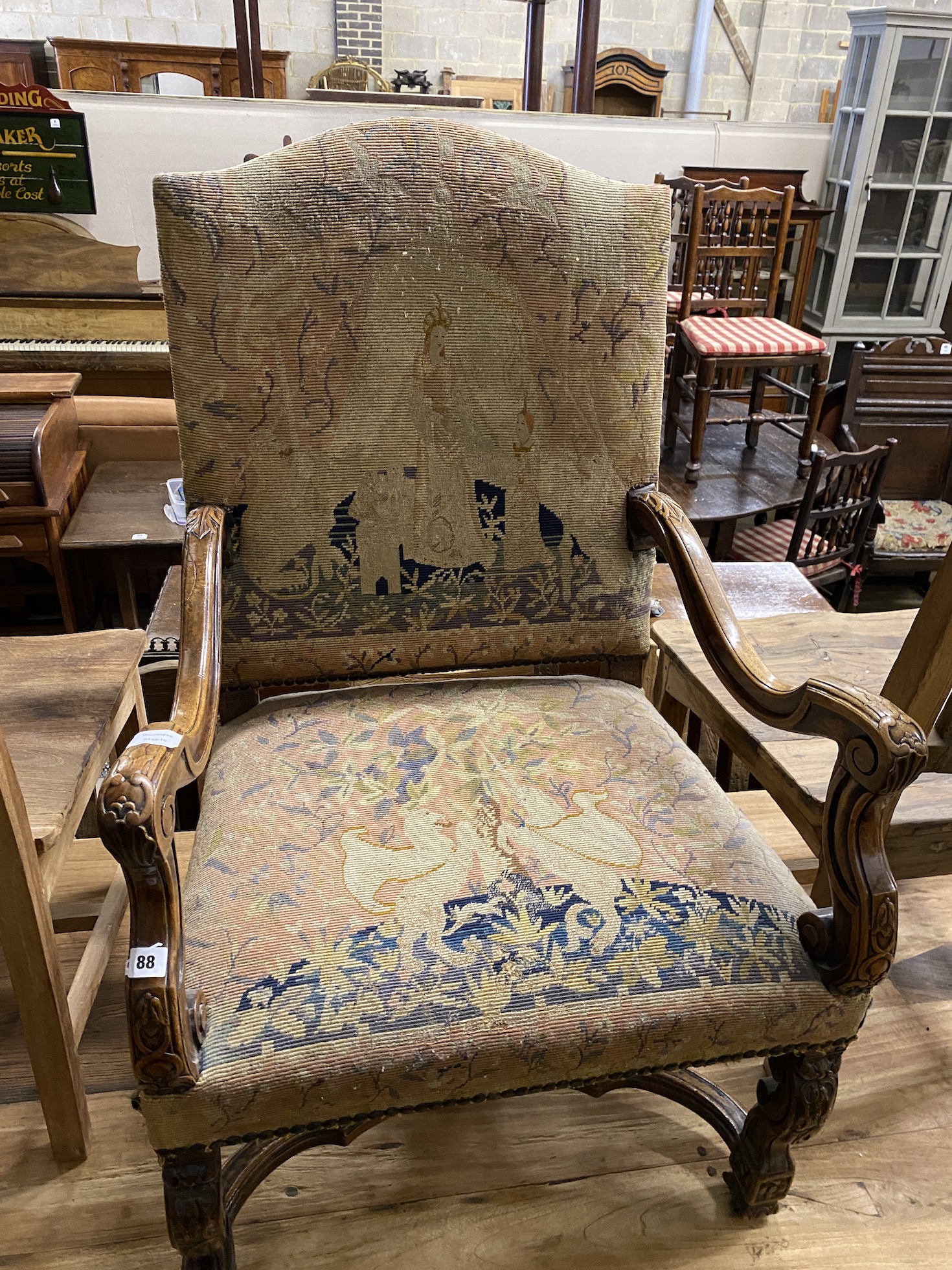 An upholstered carved walnut elbow chair, width 69cm, depth 60cm, height 110cm